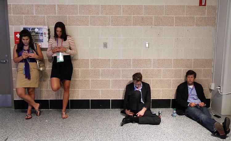 Young politicos find a quiet spot to check their smartphones at the 2012 Republican National Convention in the Tampa Bay Times Forum, Wednesday, August 29, 2012, in Tampa, Florida. (Tom Fox/Dallas Morning News/MCT)