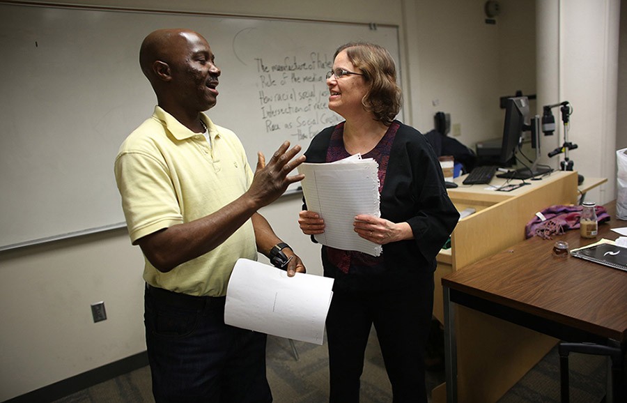 Student James David, left, laughs with professor Anne Winkler-Morey as they talk about an assignment on March 5, 2014. Winkler-Morey teaches as an adjunct professor at Metro State University in Minneapolis. (Kyndell Harkness/Minneapolis Star Tribune/MCT)