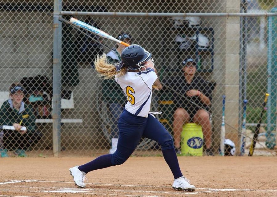 Mesa Olympian taking a swing that ended in them completing a run. Picture credit to SD Mesa Softball Facebook.
