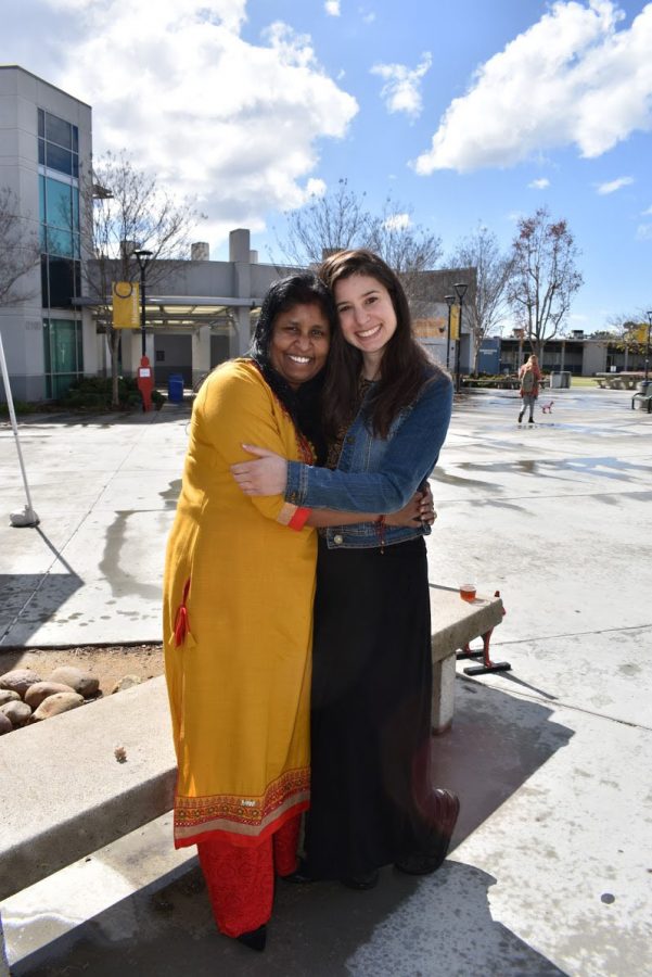 Renuka Zellars (Left) and Jenna Christakis sharing an embrace after Zellars explained her experience with labor trafficking as a young child