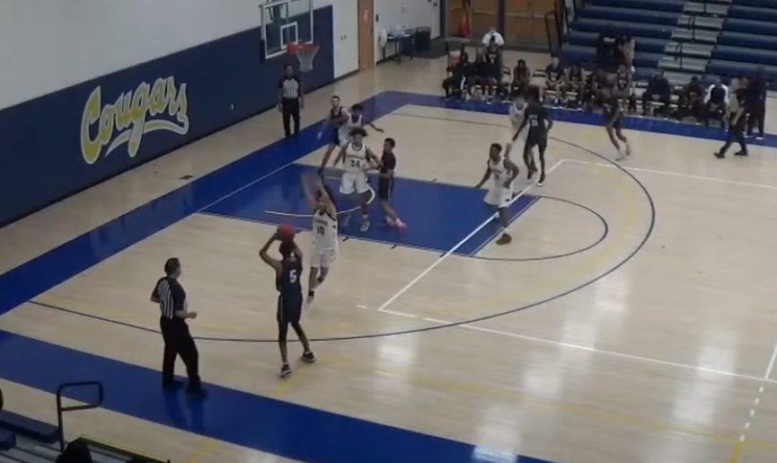 Sean Smith (#5, Blue) takes a 3 pointer during San Diego Mesa's game against College of the Canyons.