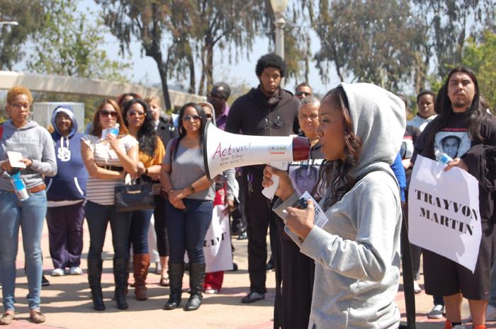Brisa Johnson, a black studies and public relations major at San Diego Mesa College and San Diego City College, speaks to the crowd during the Trayvon Marin rally on March 30 at Balboa Park. Johnson’s wish is that someday parents will be able to fully protect their children from injustices. “One thing that really hits home for me is the fact that we live in a society that is so violent that our children aren’t even safe, and when a mother can’t protect her children we have to stand up and say ‘enough is enough,’” Johnson said. Photo by Lauren J. Mapp/Editor-in-Chief