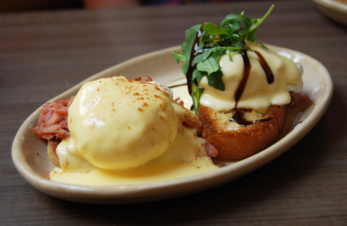 The mix and match eggs Benedict lets you diversify your breakfast meal at Snooze. Featured here is a traditional-style Ham Benedict III with smoked cheddar hollandaise sauce [left] and the Bella! Bella! Benny with prociutto, arugala and balsamic glaze [right]. Photo by Lauren J. Mapp