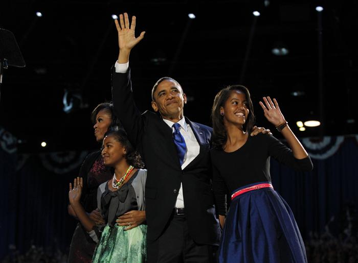 President Barack Obama greets the crowd at his election-night headquarters with his wife, Michelle, left, and daughters Sasha and Malia, right, as they celebrate his re-election on Wednesday, November 7, 2012, in Chicago, Illinois. (Brian Cassella/Chicago Tribune/MCT)