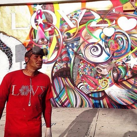 Chor Boogie in front of a mural from his Love series.