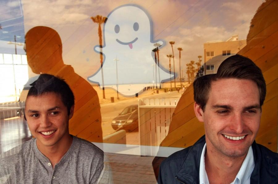 Bobby Murphy, 24, left, and Evan Spiegel, 22, co-creators of Snapchat, are seen through a window of the companys offices on Ocean Front Walk on May 6, 2013 in Venice, Calif. In 2013, co-founder Reggie Brown sued his former colleages and venture capitalists, alleging breach of contract. (Genaro Molina/Los Angeles Times/TNS)