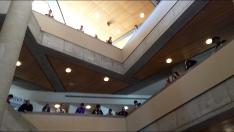 Students crowd around in the LRC to see the Vocal Ensemble perform a modified version of "Bach Again - Come Sweet Death."