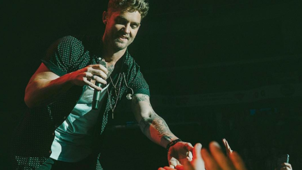 Brett Young interacts with fans at recent concert.