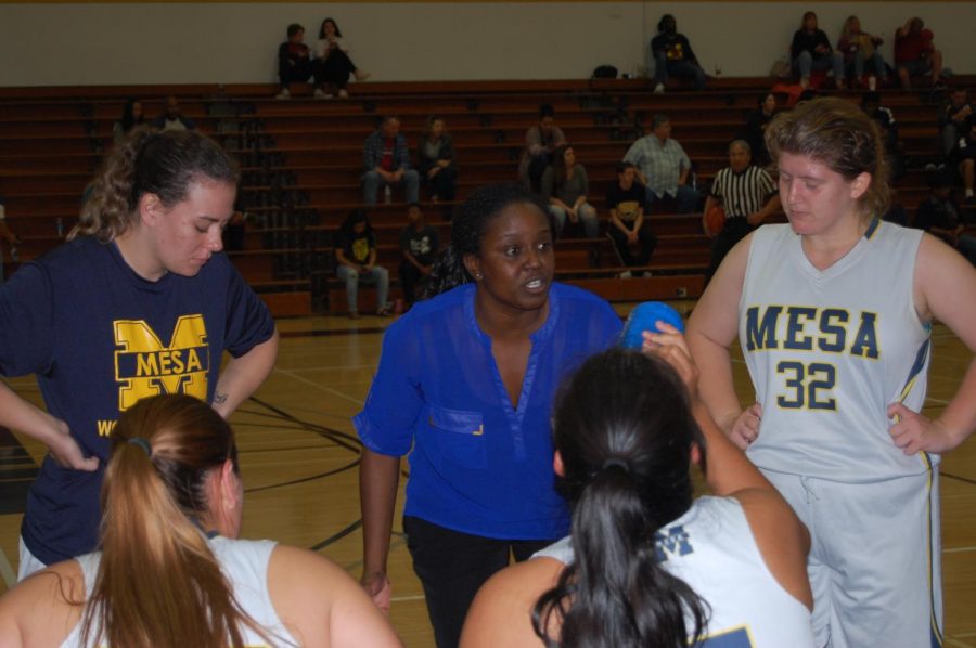 Coach Dee James talks to her team during a timeout break vs Palomar