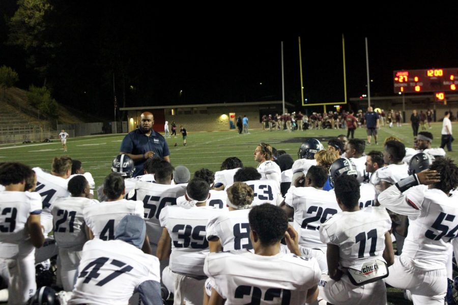 Mesa Olympians Coach Gary Watkins addresses the team on the field after their season opening loss to the Southwestern Jaguars at DeVore Stadium.