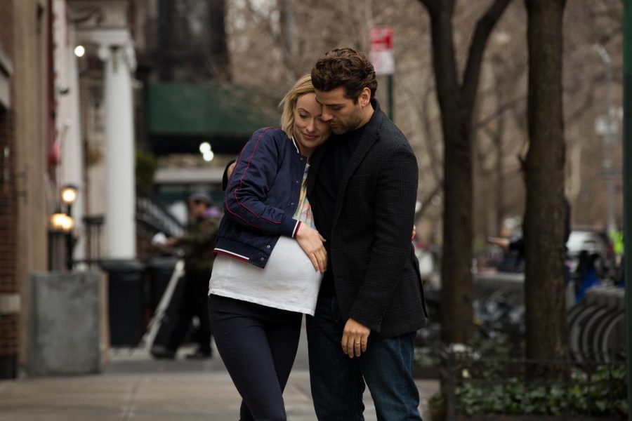 Happy couple Will (Oscar Isaac) and Abby (Olivia Wilde) share a sweet embrace in the streets of New York City.