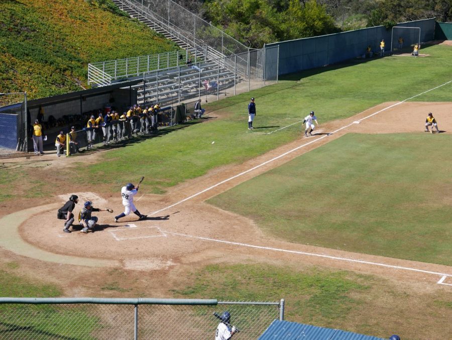 No. 28, Jorge Martinez, Sophomore, sends a rocket out to left field. Photo Credit - Erik Acosta.