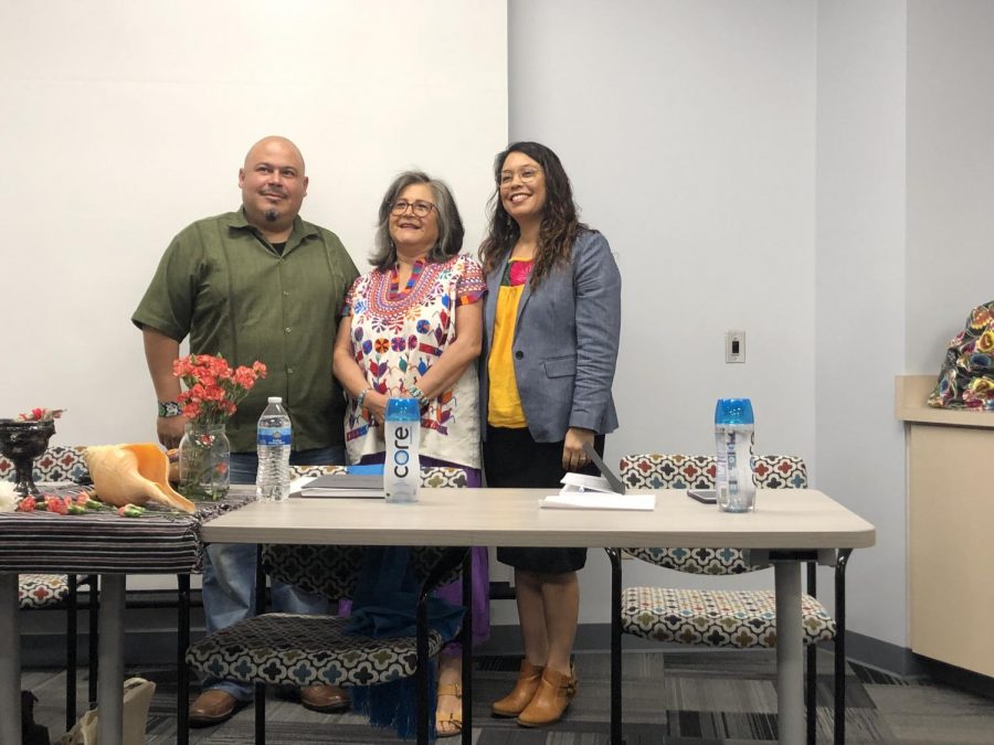 From left to right,  panelists Roberto D. Hernandez, Maria Figueroa and Bea Zamora pose as Mesa students take their picture  to commemorate the Danza Azteca event. 