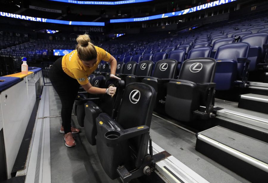 Workers clean the Bridgestone Arena in Nashville, Tenn. after the SEC basketball championship was canceled during play. Photo Credit: MCT Campus