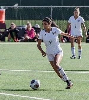 Ravelo dribbing the ball down field ready to make a goal.