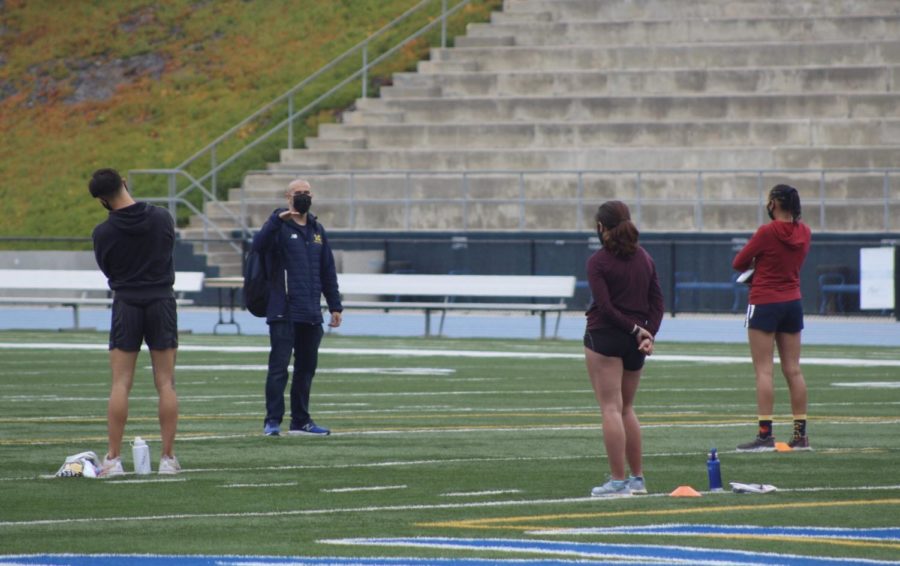 Sean+Ricketts%2C+head+coach+of+track+and+field%2C+welcoming+back+his+athletes+and+prepares+them+for+the+workout.