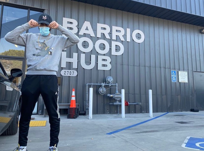 Willie Wingz posing in front of Barrio Food Hub via instagram @willie_wingz