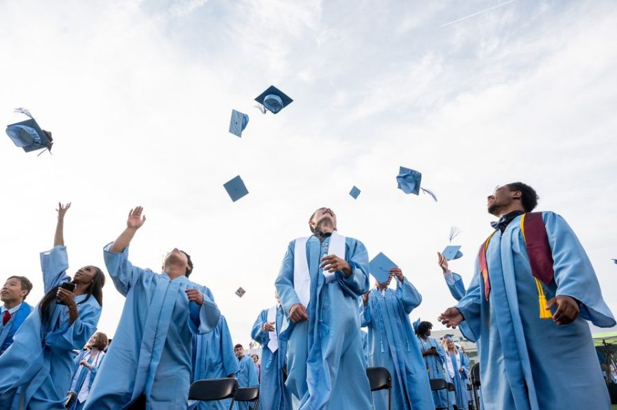 Graduates toss their caps during Skylines Class of 2021 commencement.