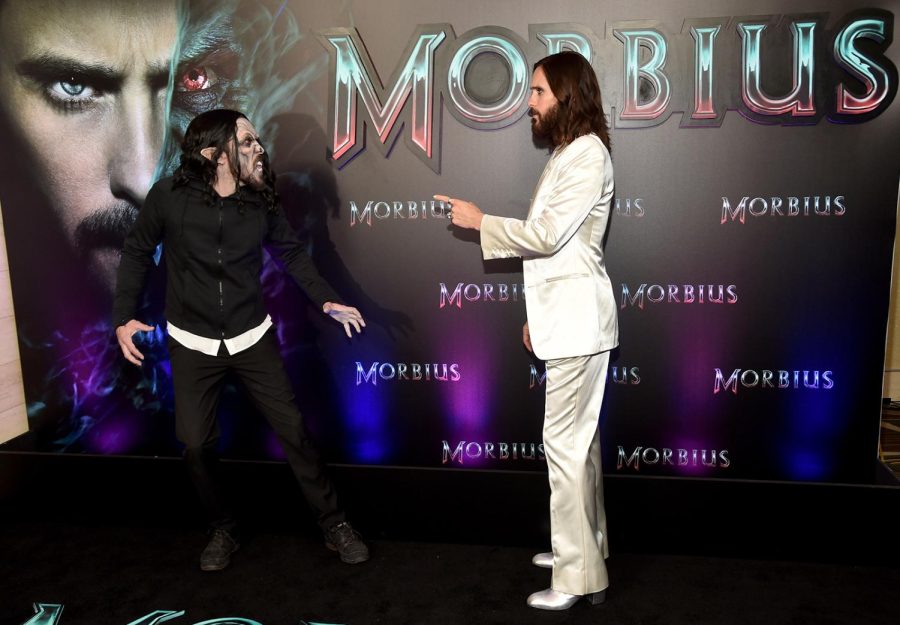 Jared Leto being greeted by his stunt double walking into the theater trying to avoid any more blood stains on his perfect all white suite ready for the premiere.