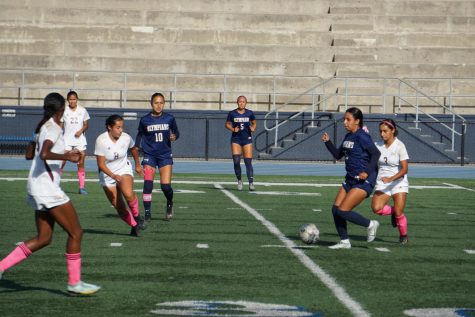 (From Left to Right) Marlene Lopez, Julia Widmer, and Nancy Segovia drive the ball down the field, into enemy territory