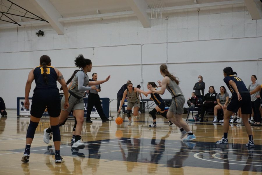 Kayla Sabri (Center) drives the ball down the court.