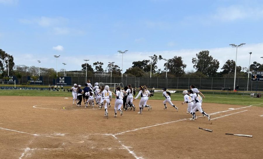 Carlotta Gonzalez’s team greeted her at second base to celebrate the Olympians’ 5-4 walk-off win. Photo Credit: Clay Fordham/The Mesa Press.