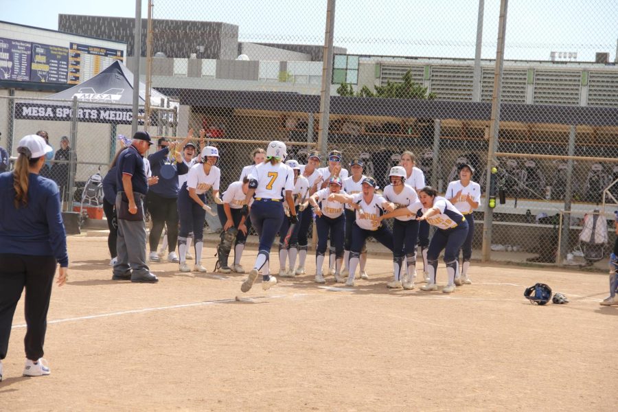 Ambria+Guyes+teammates+wait+at+home+plate+to+celebrate+her+game-tying+home+run+in+the+bottom+of+the+fourth+inning.+Photo+Credit%3A+Daniel+Betancourt.