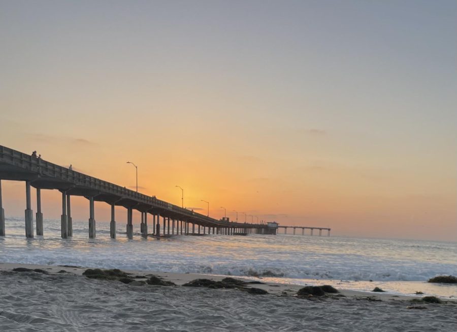 The sun sets over the Ocean Beach Municipal Pier before its closure to the public.