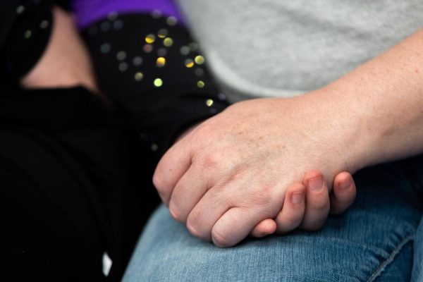 Elaine Harkey, 16, holds hands with her mother Charity Harkey-Vail in downtown Oklahoma City, Okla. on Saturday, Feb. 18, 2023. Harkey was enrolled in a residential program for teenagers with autism at Fort Behavioral Health before it was abruptly shut down by the state of Texas last month.