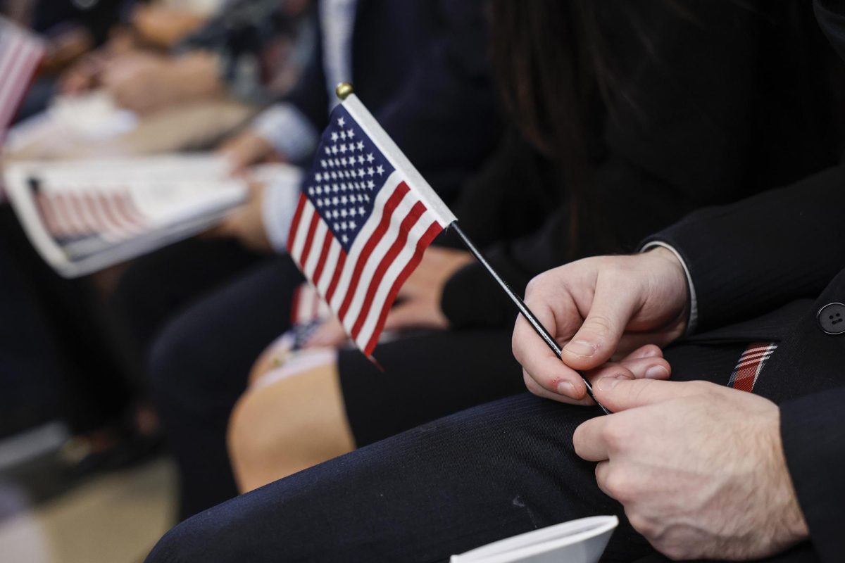 A Ukrainian immigrant holds an American flag during a U.S. Citizenship and Immigration Services naturalization ceremony.