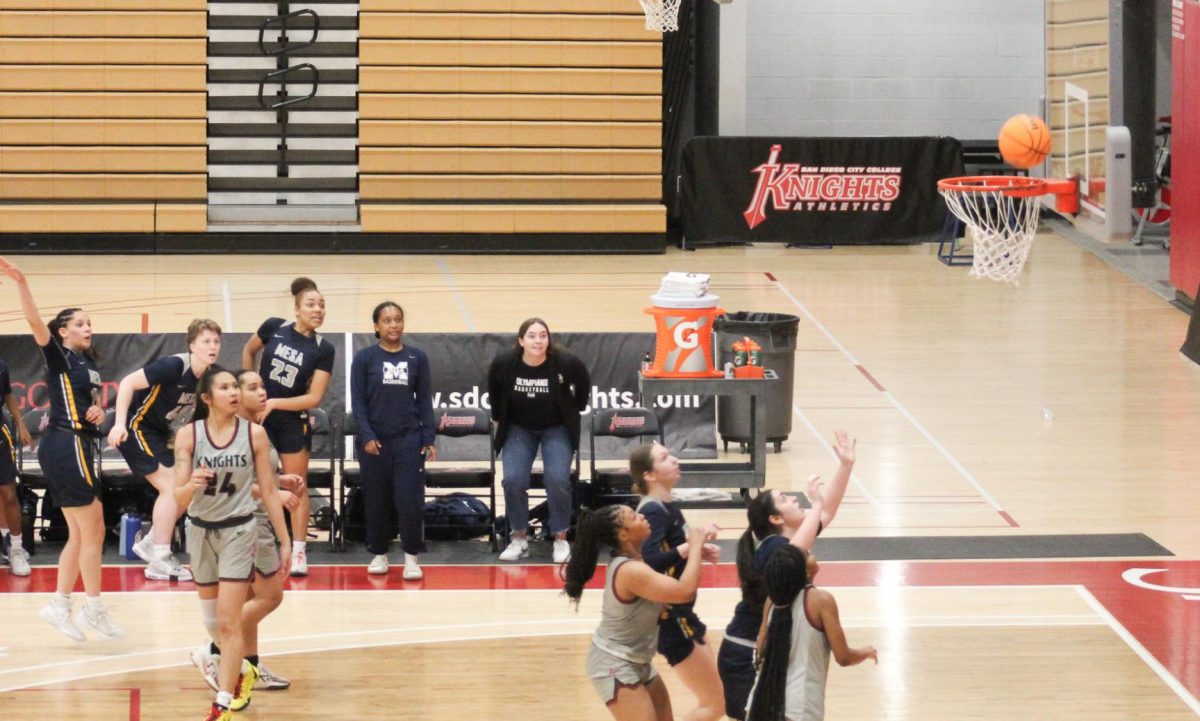 San Diego Mesa and City college players hold their breath as the game winning 3-point shot falls.