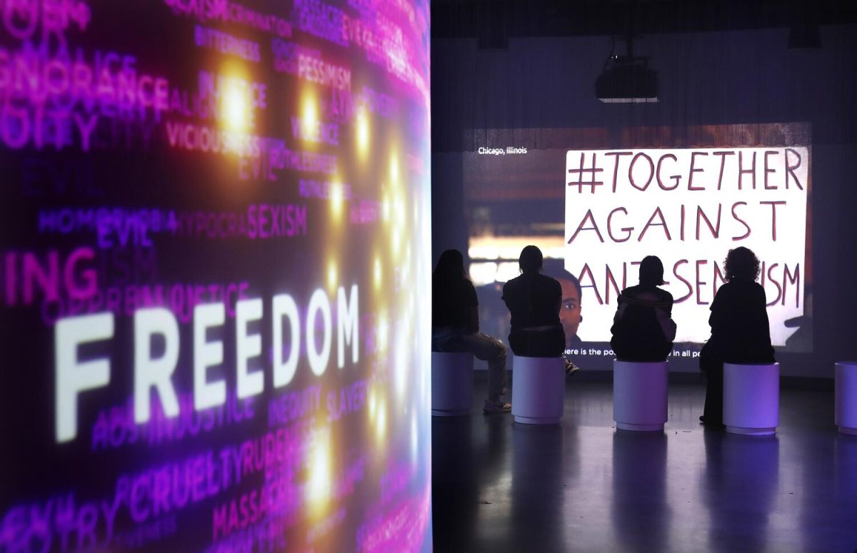 Visitors at the Museum of Tolerance in Los Angeles watch a video presentation about anti-Semitism.