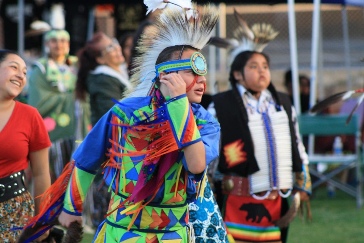 Dancer with traditional regalia participating in intertribal dancing. 